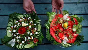 A waiter presents two types of salad served by Habibi restaurant in Peshawar, Pakistan January 31, 2018.