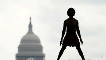 A homeless man stretches on the National Mall in Washington