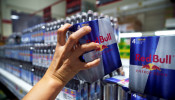 A woman buys Red Bull energy drink cans in a supermarket in Bangkok, Thailand, August 4, 2020.