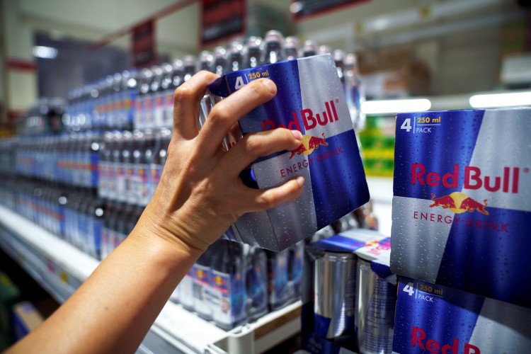 A woman buys Red Bull energy drink cans in a supermarket in Bangkok, Thailand, August 4, 2020.