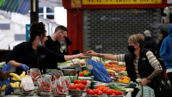 A woman does groceries as restrictions in the city have started to ease