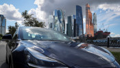 A Tesla Model 3 electric vehicle is shown in Moscow