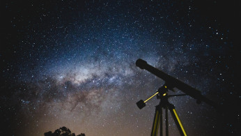 Black Telescope Under Blue and Black Sky