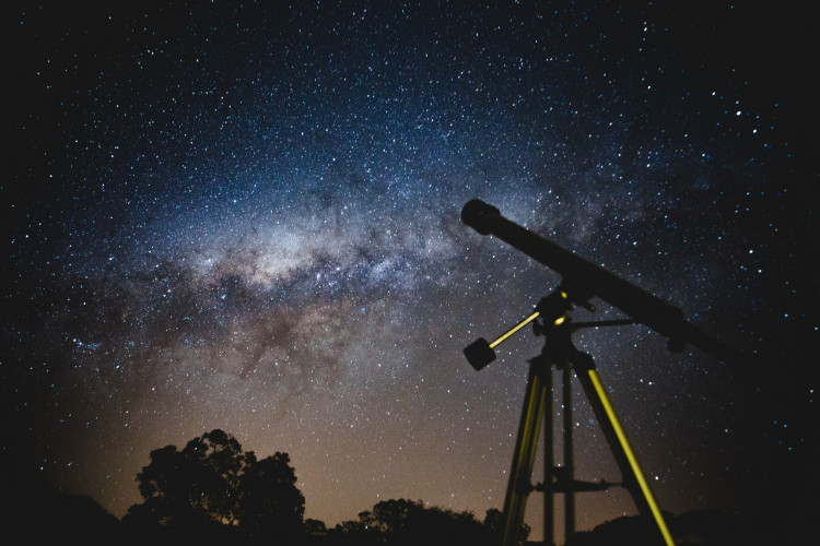 Black Telescope Under Blue and Black Sky