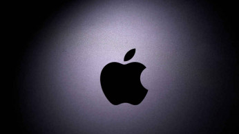 Apple logo is seen on the Macbook in this illustration taken