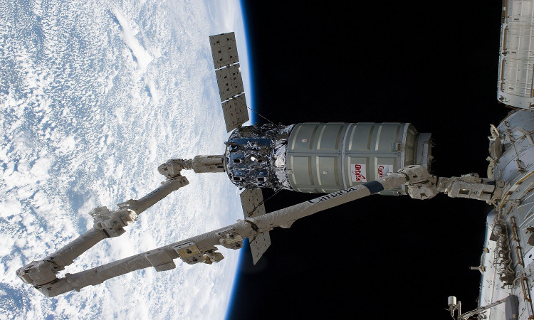 The International Space Station's Canadarm2 unberths the Orbital Sciences Corporation's Cygnus spacecraft after several weeks at the space station