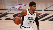NBA: LA Clippers guard Paul George (13) brings the ball up court against the Denver Nuggets