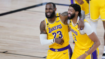 NBA: Los Angeles Lakers' LeBron James (23) and Anthony Davis (3) celebrate after defeating the Denver Nuggets 124-121
