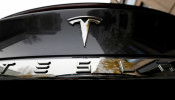 FILE PHOTO: The company logo is pictured on a Tesla Model X electric car in Berlin, Germany, November 13, 2019