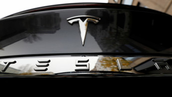 FILE PHOTO: The company logo is pictured on a Tesla Model X electric car in Berlin, Germany, November 13, 2019