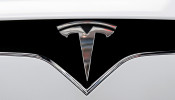 FILE PHOTO: The Tesla logo is seen on a car at Tesla's new showroom in Manhattan