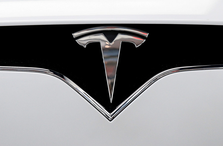 FILE PHOTO: The Tesla logo is seen on a car at Tesla's new showroom in Manhattan