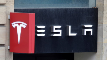 The logo of Tesla is seen on a store in Paris, France, October 30, 2020