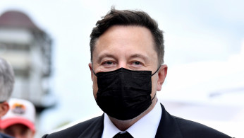FILE PHOTO: Elon Musk wears a protective mask as he arrives to attend a meeting with the leadership of the conservative CDU/CSU parliamentary group, in Berlin
