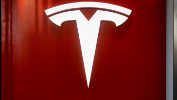 FILE PHOTO: The Tesla logo is seen at the entrance to Tesla Motors' showroom in Manhattan's Meatpacking District in New York City