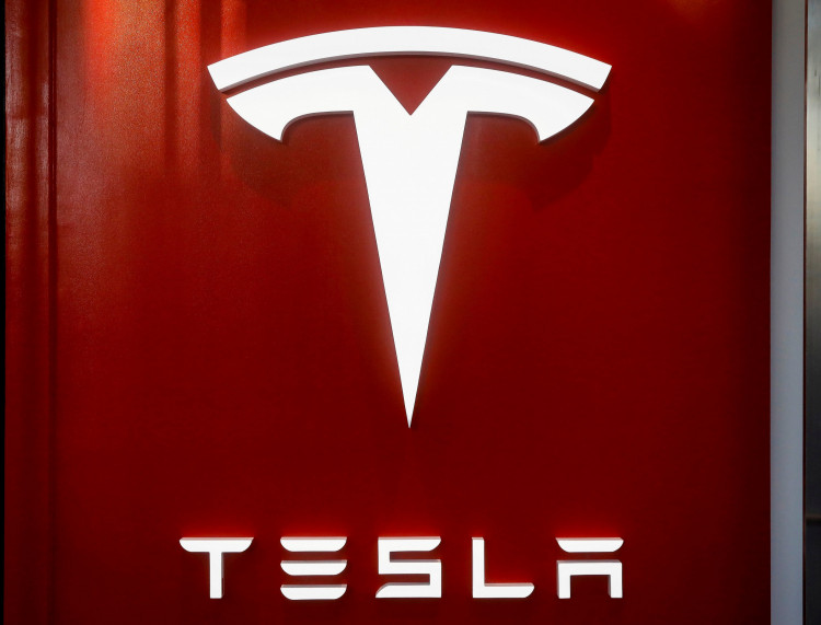 FILE PHOTO: The Tesla logo is seen at the entrance to Tesla Motors' showroom in Manhattan's Meatpacking District in New York City