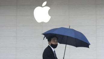 FILE PHOTO: Man walks past an Apple store in Taipei
