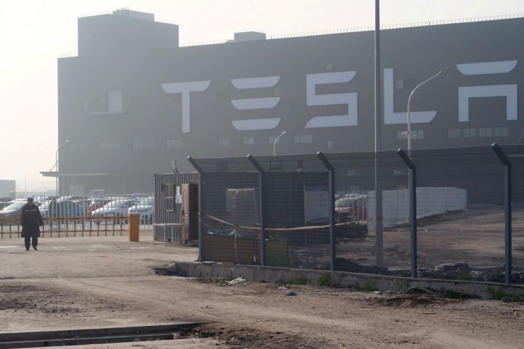 FILE PHOTO: A Tesla sign is seen on the Shanghai Gigafactory of the U.S. electric car maker