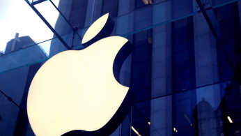 FILE PHOTO: The Apple Inc logo is seen hanging at the entrance to the Apple store on 5th Avenue in Manhattan, New York, U.S., October 16, 2019