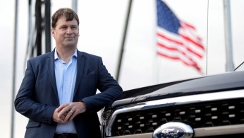 FILE PHOTO: Ford Motor Co. CEO Jim Farley poses next to a new 2021 Ford F-150 pickup truck at the Rouge Complex in Dearborn,