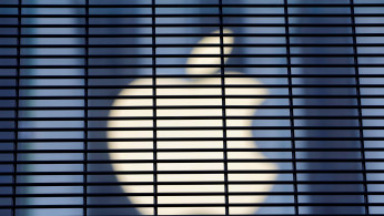 FILE PHOTO: The Apple logo is seen through a security fence erected around the Apple Fifth Avenue store