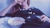 happy woman eating popcorn