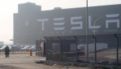FILE PHOTO: A Tesla sign is seen on the Shanghai Gigafactory of the U.S. electric car maker in Shanghai, China, Dec. 30, 2019