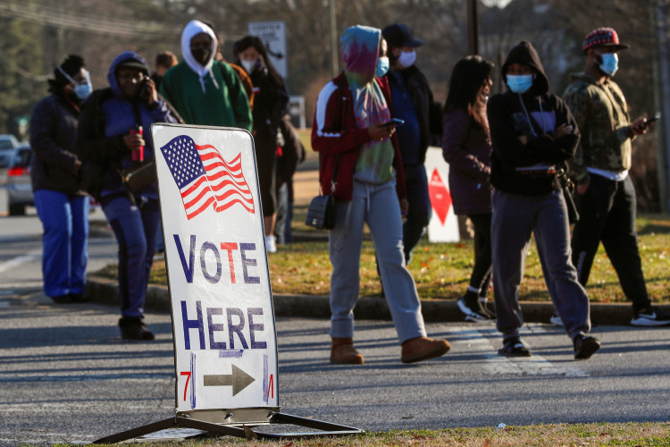 A sign is seen as voters line up for the U.S. Senate run-off election, at a polling location in Marietta, Georgia