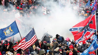  Tear gas is released into a crowd of protesters during clashes with Capitol police
