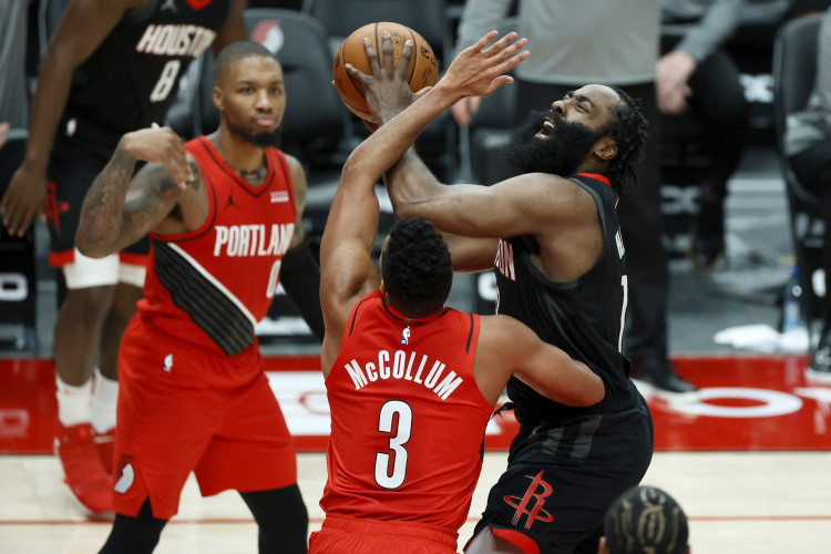 NBA: Houston Rockets shooting guard James Harden (13) is fouled while shooting by Portland Trail Blazers shooting guard CJ McCollum (3)