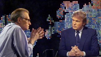 Billionaire real estate developer Donald Trump (R) talks with host Larry King after taping a segment of King's CNN talk show, in New York, U.S., October 7, 1999. REUTERS/File Photo