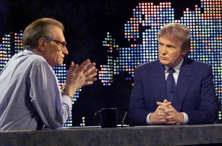 Billionaire real estate developer Donald Trump (R) talks with host Larry King after taping a segment of King's CNN talk show, in New York, U.S., October 7, 1999. REUTERS/File Photo
