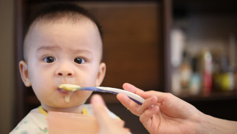 person feeding baby