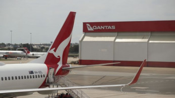 A crew member walks from a Qantas plane at a domestic terminal at Sydney Airport.
