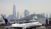 A United Airlines passenger jet takes off with New York City.