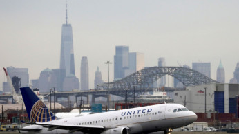 A United Airlines passenger jet takes off with New York City.