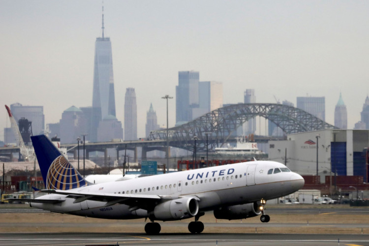 A United Airlines passenger jet takes off with New York City.