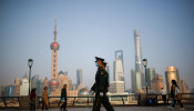 Paramilitary police officers march at the Bund, in front of Lujiazui financial district of Pudong.