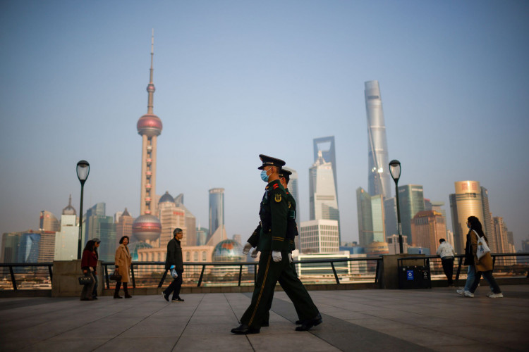 Paramilitary police officers march at the Bund, in front of Lujiazui financial district of Pudong.
