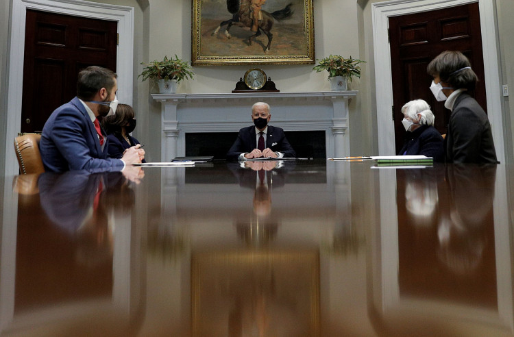 U.S. President Joe Biden is flanked by Vice President Kamala Harris and Treasury Secretary Janet Yellen.
