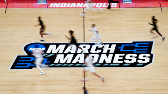 A detailed view of the March Madness logo at center court as Gonzaga Bulldogs and Norfolk State Spartans players.