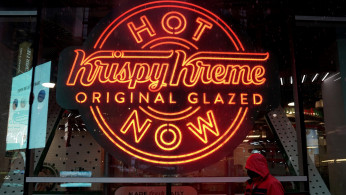 FILE PHOTO: A man walks past a Krispy Kreme 