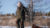 Russian President Vladimir Putin walks through snow during a holiday in the Siberian taiga.