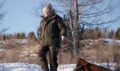 Russian President Vladimir Putin walks through snow during a holiday in the Siberian taiga.