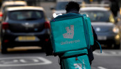 FILE PHOTO: A Deliveroo delivery rider cycles in London, Britain, March 8, 2021. 
