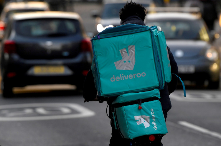 FILE PHOTO: A Deliveroo delivery rider cycles in London, Britain, March 8, 2021. 