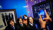 Visitors take photos with the wax figures of the Beatles at a wax museum. 