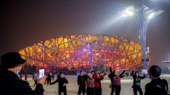 People are seen in front of the National Stadium, also known as Birds' Nest, in Beijing, China.