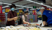 People look at fresh seafood in a supermarket in Beijing, China.