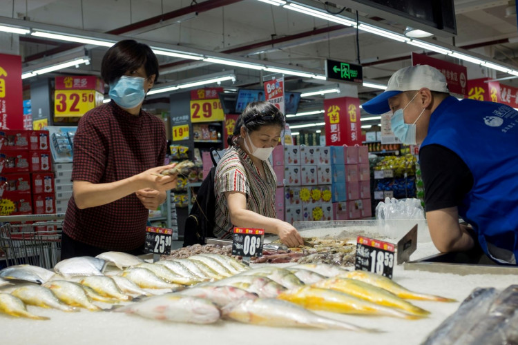 People look at fresh seafood in a supermarket in Beijing, China.